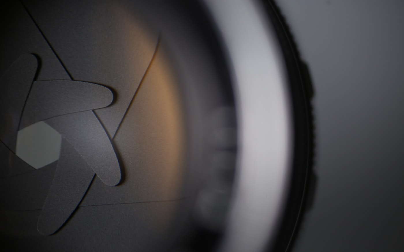 Macro of a headphone driver housing, the ring around the diaphragm falling out of focus.